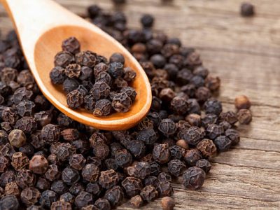 close up of black peppercorn in wooden teaspoon; Adobe RGB color space; see other similar images: